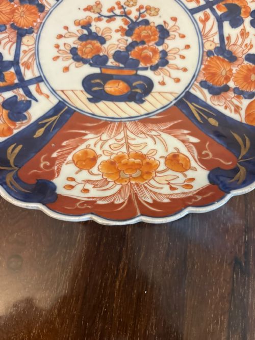 fig 3. A pair of antique Japanese Imari porcelain plates featuring scalloped edges, cobalt blue and orange floral panels, and a central floral motif.
