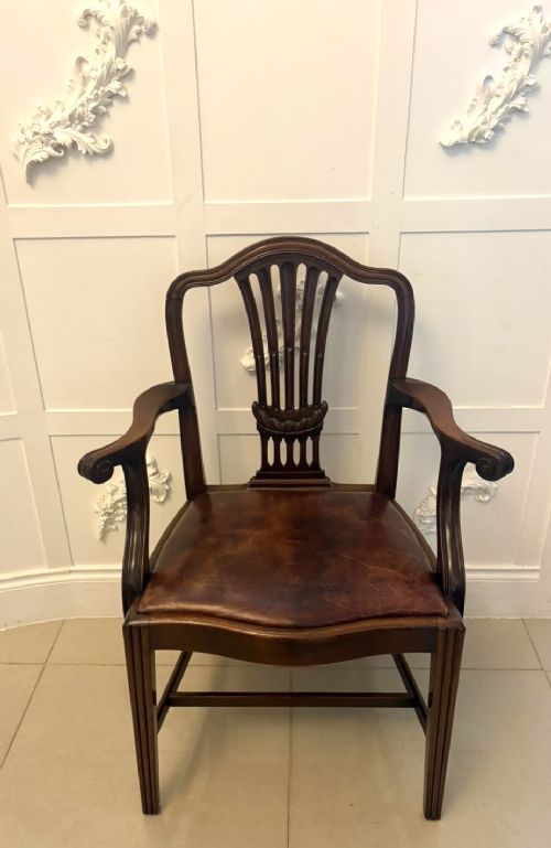 fig 2. A set of Victorian mahogany Hepplewhite style dining chairs featuring shield-shaped backs with carved splats and tan leather upholstered seats.