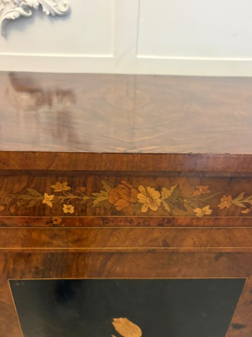 fig 2. A nineteenth-century Victorian burr walnut credenza featuring curved side doors, intricate floral marquetry inlays, and gilt bronze mounts.