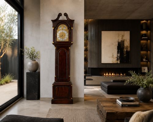 fig 1. An antique Victorian dark mahogany longcase clock with a swan-neck pediment, ornate brass dial, arched trunk door, and stepped base.