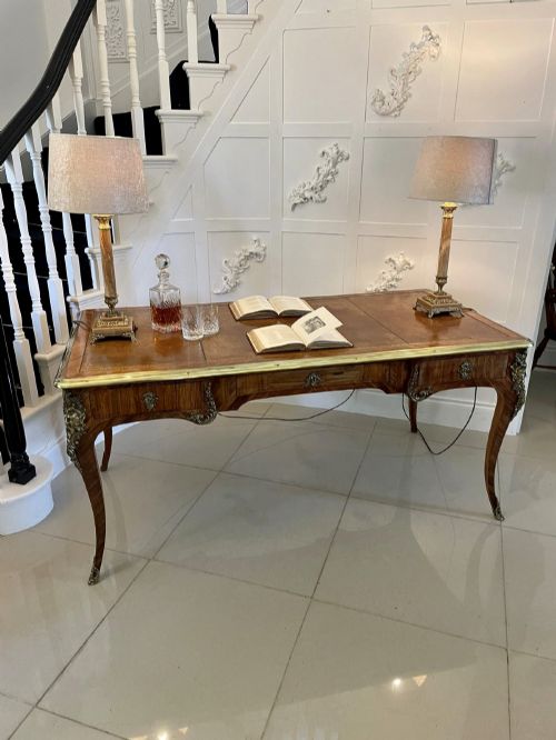 fig 4. A French Louis XV style kingwood bureau plat featuring cabriole legs with ormolu mounts, three frieze drawers, and a leather inset writing surface.