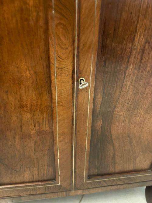 fig 3. An antique Regency mahogany chiffonier side cabinet featuring intricate floral brass inlay on the doors and frieze with an upper open shelf.