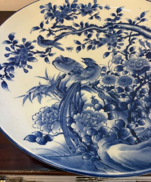 fig 5. A pair of large circular blue and white Chinese porcelain chargers decorated with hand-painted birds and flowering branches.