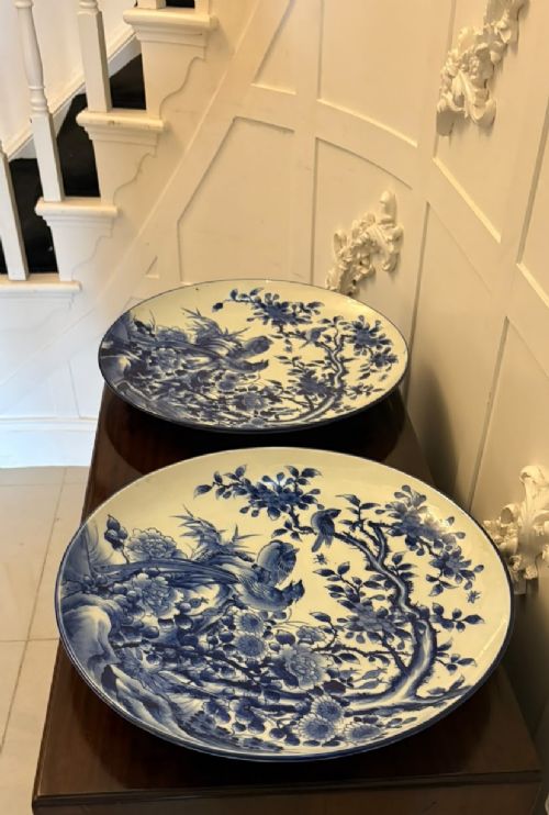 A pair of large circular blue and white Chinese porcelain chargers decorated with hand-painted birds and flowering branches. View XIV