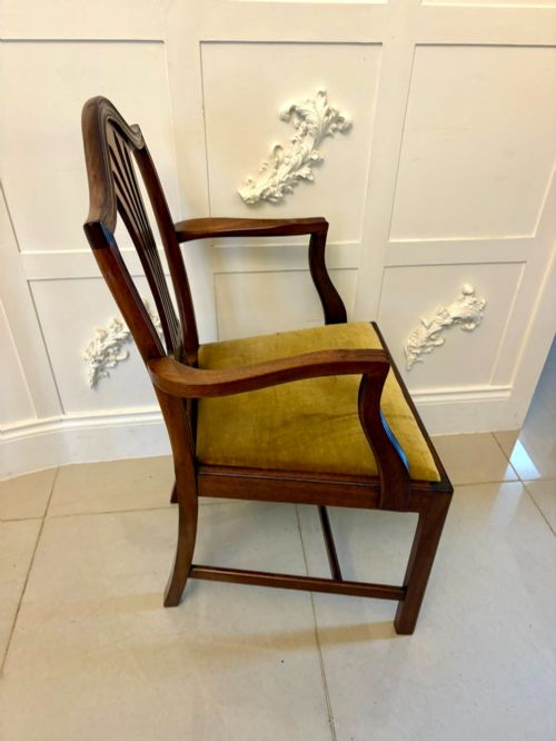 fig 1. A set of twelve mahogany Hepplewhite style dining chairs featuring shield backs with carved splats and gold velvet drop-in seats.