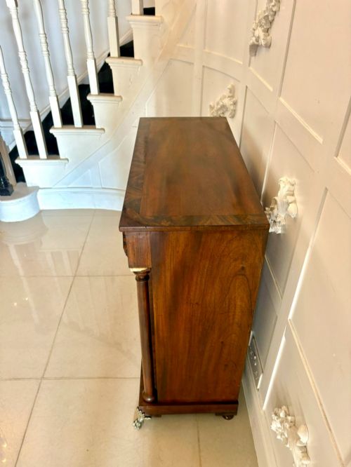 fig 1. An antique Regency mahogany chiffonier cabinet featuring flame mahogany double doors, turned side columns, diamond detailing, and metal claw feet.