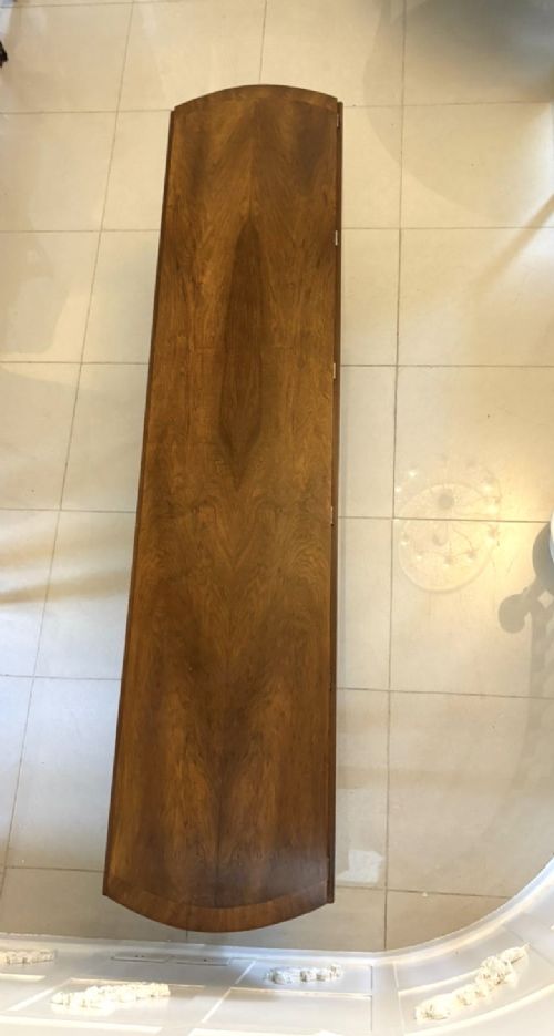 A large oval figured walnut wake dining table featuring drop leaves and cabriole legs ending in pad feet. View X