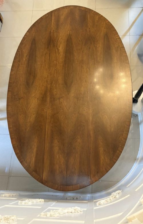 A large oval figured walnut wake dining table featuring drop leaves and cabriole legs ending in pad feet. View XI