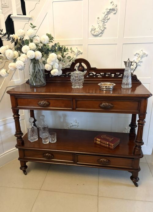 fig 3. A Victorian mahogany buffet server featuring an openwork carved gallery back, four drawer compartments, turned columns, and an open lower shelf.