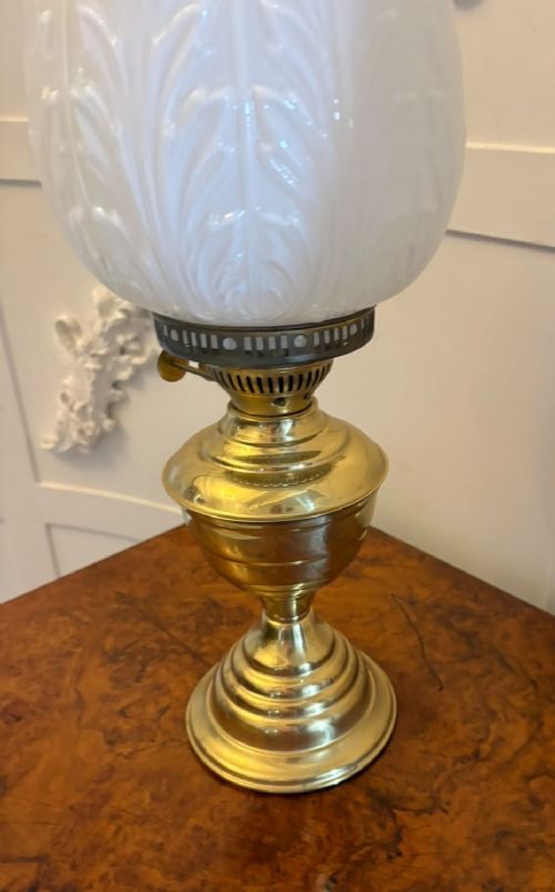 A near pair of Edwardian brass oil lamps featuring moulded white opaline glass shades and clear glass chimneys. View VI