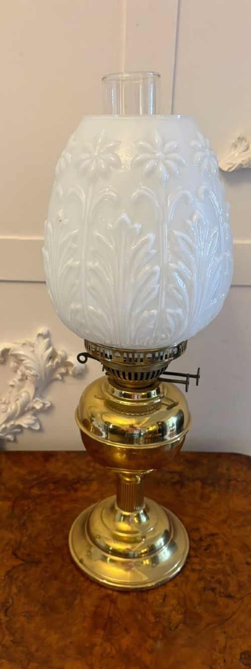 A near pair of Edwardian brass oil lamps featuring moulded white opaline glass shades and clear glass chimneys. View VIII