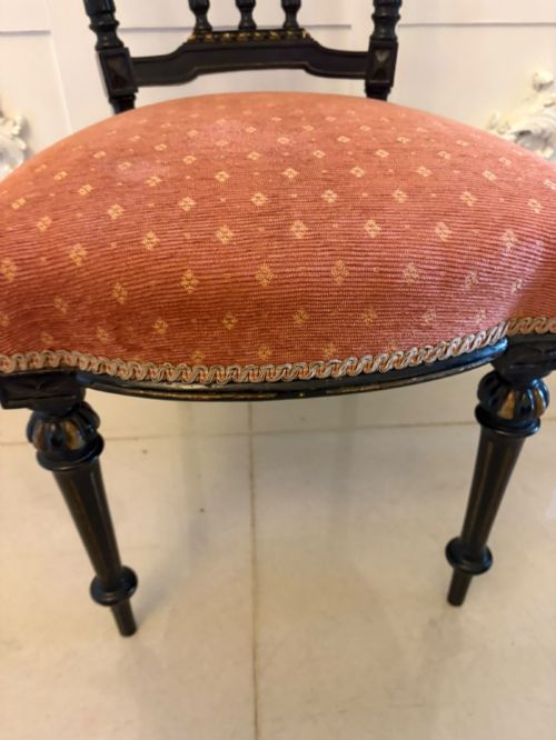 fig 3. A set of four antique Victorian side chairs featuring ebonised black frames with turned spindle backrests, gilt details, turned front legs, and terracotta patterned upholstered seats.