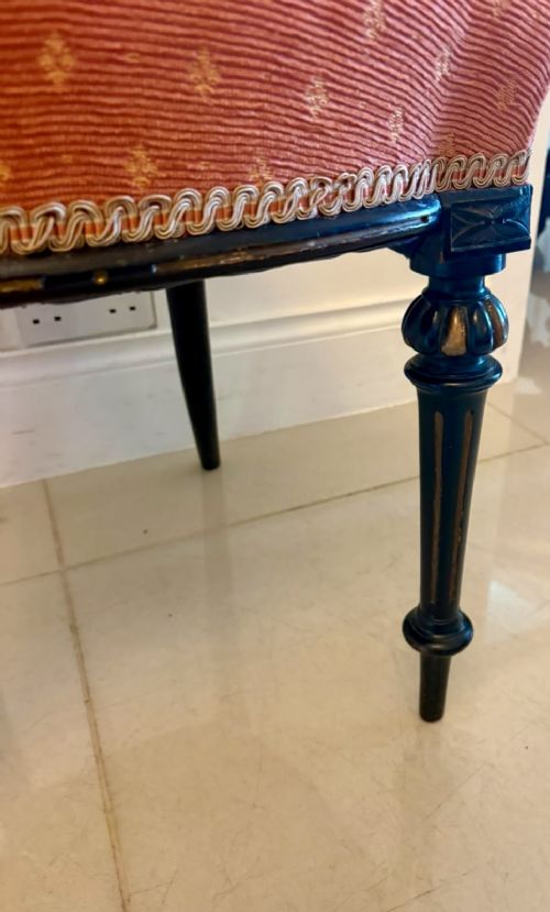 fig 4. A set of four antique Victorian side chairs featuring ebonised black frames with turned spindle backrests, gilt details, turned front legs, and terracotta patterned upholstered seats.
