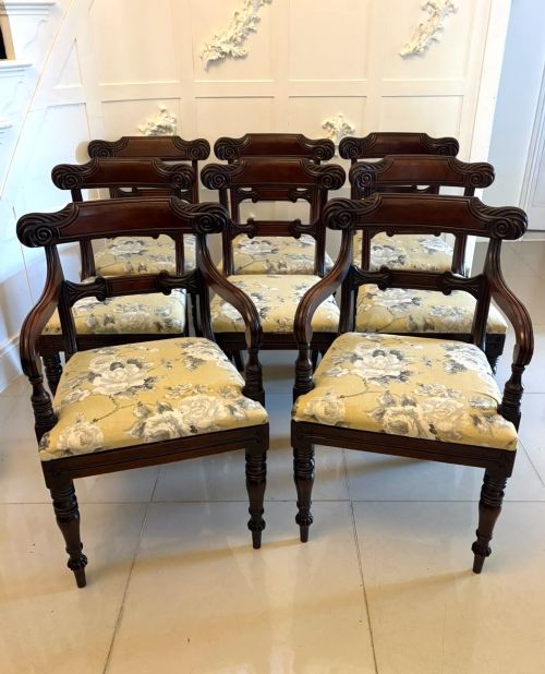 fig 1. A set of eight Regency mahogany dining chairs comprising six side chairs and two carver armchairs with scroll-carved top rails and turned front legs.