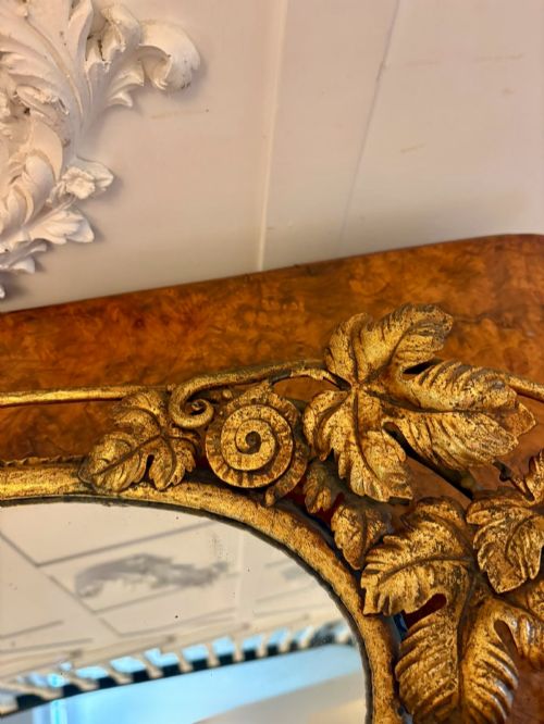 fig 3. An oval gilt metal tray featuring a central mirror panel surrounded by an ornate border of sculpted grapevines, leaves, and grape clusters.