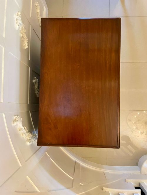 fig 2. A George III mahogany chest of drawers featuring a two-over-three drawer configuration with brass swan-neck handles on bracket feet.