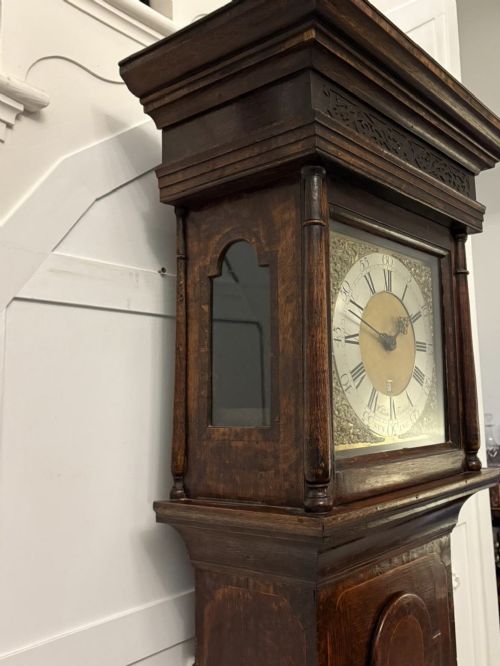 A George III oak and burr oak longcase clock featuring a square brass dial, fretwork hood frieze, and a long waist door. View VIII