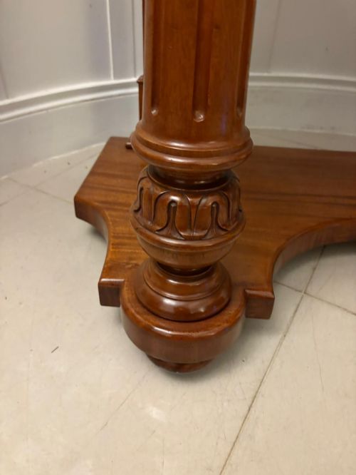 fig 2. An antique Victorian carved mahogany dressing table featuring an arched swivel mirror, twin trinket drawers, turned front columns, and a shaped lower shelf.