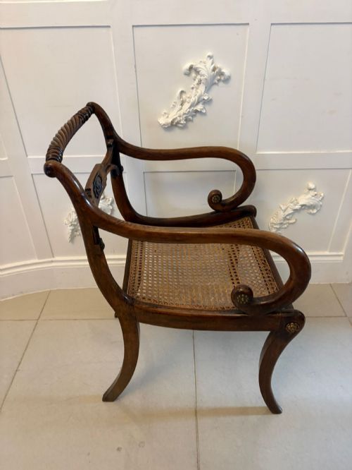 fig 4. A set of six dark mahogany Regency dining chairs featuring rope-twist top rails, curved sabre legs, and woven cane seats.