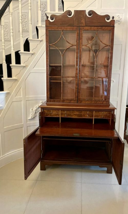 An antique Regency mahogany secretaire bookcase featuring a top scroll pediment, glazed upper doors with astragal moulding, and a lower double cupboard. View XIII