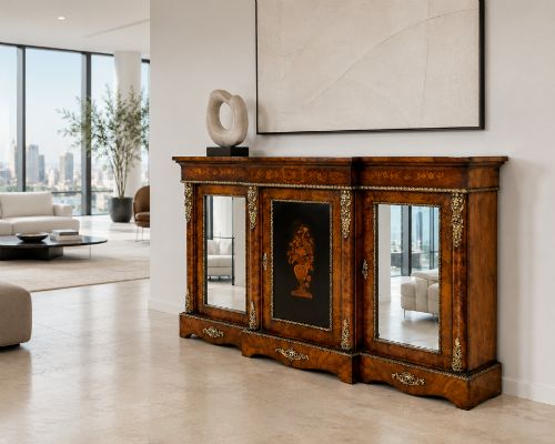 fig 1. A Victorian burr walnut breakfront credenza featuring brass mounts, a central floral marquetry panel, and mirrored side doors.