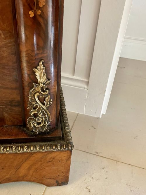 fig 5. A Victorian burr walnut breakfront credenza featuring brass mounts, a central floral marquetry panel, and mirrored side doors.