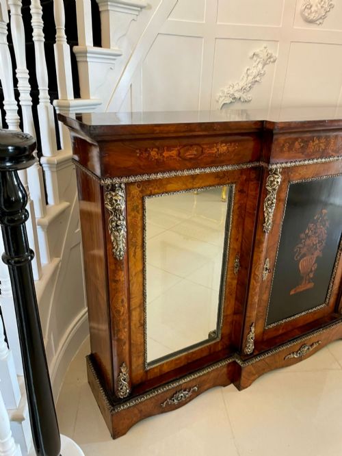 fig 7. A Victorian burr walnut breakfront credenza featuring brass mounts, a central floral marquetry panel, and mirrored side doors.