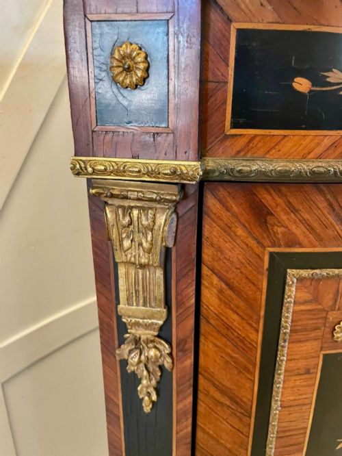 fig 1. A French Louis XVI style corner cabinet featuring a bow-front door with floral wood marquetry inlay, gilt bronze mounts, and a fitted white marble top.
