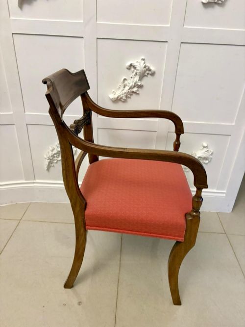 fig 2. A set of twelve Regency mahogany dining chairs featuring tablet top back rails, carved crossbars, and terracotta fabric upholstered seats, including two carvers with curved armrests.