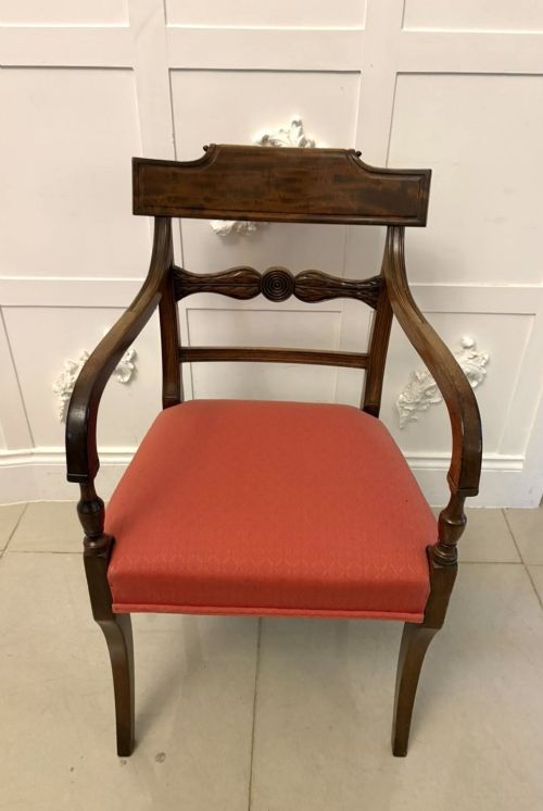 fig 3. A set of twelve Regency mahogany dining chairs featuring tablet top back rails, carved crossbars, and terracotta fabric upholstered seats, including two carvers with curved armrests.