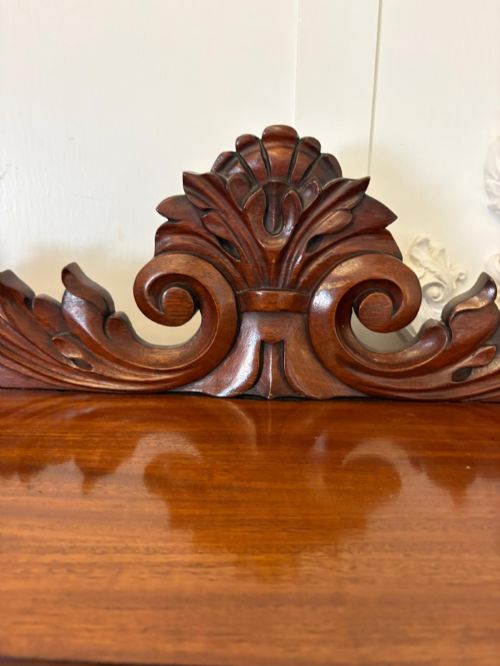 fig 2. A Victorian mahogany chiffonier featuring a two-tiered upper shelf superstructure with carved scroll supports and a lower cupboard with flame mahogany veneered doors.