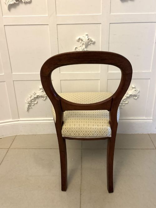 fig 1. A set of four antique Victorian mahogany dining chairs featuring open balloon-shaped backrests, turned front legs, and cream patterned upholstery.