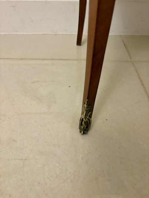 fig 1. An antique French Louis XV style wooden side cabinet featuring three marquetry drawers, brass rim, decorative corner mounts, and slender cabriole legs.