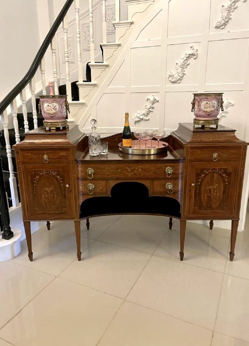 A nineteenth-century mahogany sideboard with detailed floral marquetry inlays, a stepped pedestal top, multiple drawers with brass lion mask ring handles, and tapered square legs. View II