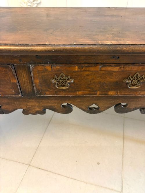 fig 2. A dark brown oak Georgian style dresser base featuring three drawers with brass drop handles, a decorative scalloped apron, and front cabriole legs.