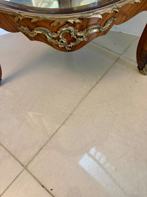 fig 3. An antique French serpentine corner display cabinet crafted from kingwood with a marble top, curved glass door, internal glass shelves, and gilded ormolu mounts.