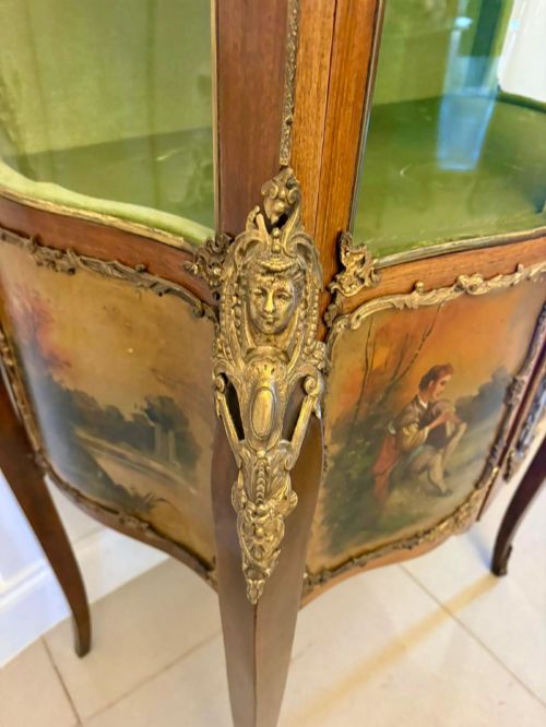 fig 1. A French Louis XV Revival Vernis Martin vitrine cabinet featuring bowed glass doors, gilt bronze mounts, painted lower panels depicting figures, and a fabric-lined interior.