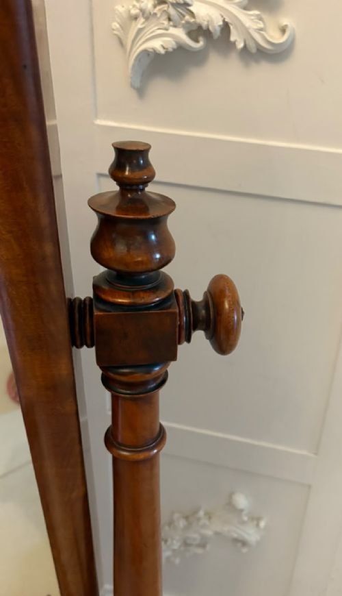 A Victorian mahogany freestanding cheval mirror featuring turned upright pillars, arched legs, and a swivelling full-length mirror frame. View XI