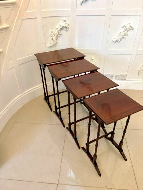 fig 2. A set of four graduated Edwardian mahogany nesting tables featuring fine satinwood inlay borders and slender turned legs on trestle feet.