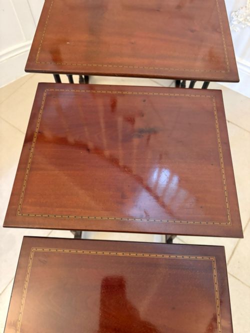 fig 4. A set of four graduated Edwardian mahogany nesting tables featuring fine satinwood inlay borders and slender turned legs on trestle feet.