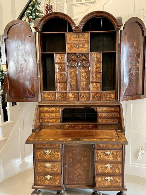 fig 1. An antique William and Mary double-dome bureau bookcase crafted from burr walnut with intricate floral marquetry inlay and ball feet.