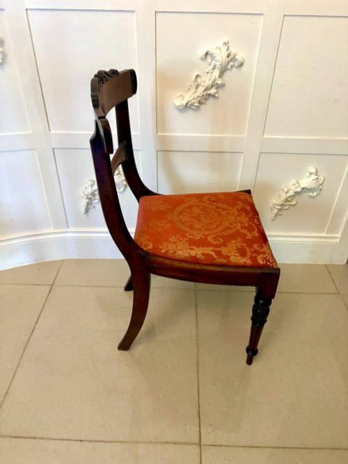 fig 1. A set of six Regency carved rosewood dining chairs featuring curved backrests with scroll details, turned front legs, and pattern-upholstered seats.