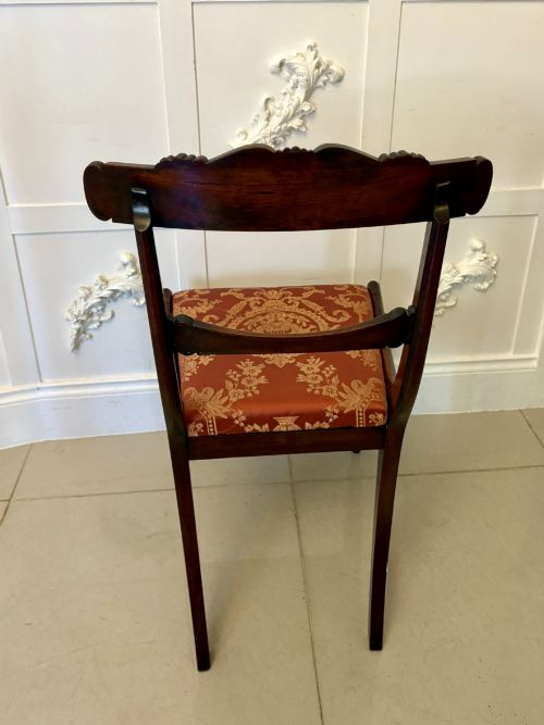 fig 2. A set of six Regency carved rosewood dining chairs featuring curved backrests with scroll details, turned front legs, and pattern-upholstered seats.