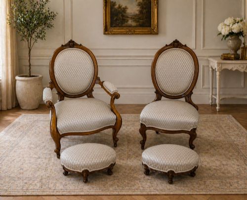fig 1. An eleven-piece antique Victorian carved walnut salon suite featuring a central sofa, pair of armchairs, six side chairs, and two footstools, all upholstered in a patterned cream fabric.