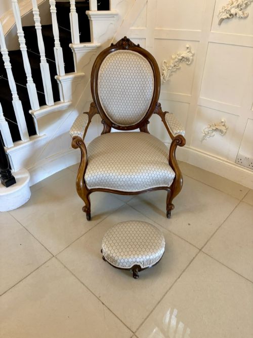 fig 3. An eleven-piece antique Victorian carved walnut salon suite featuring a central sofa, pair of armchairs, six side chairs, and two footstools, all upholstered in a patterned cream fabric.