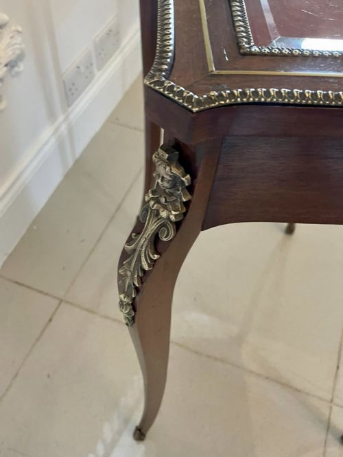 A 19th-century French mahogany bijouterie display table featuring a glazed top with brass inlay, a single front drawer, and slender cabriole legs with brass mounts. View II