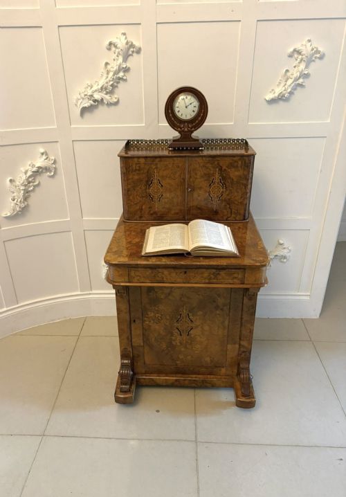 fig 2. A Victorian burr walnut Davenport desk with floral marquetry inlay, a brass top gallery, and carved scroll feet.