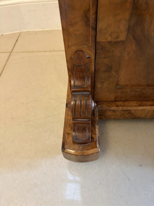 fig 3. A Victorian burr walnut Davenport desk with floral marquetry inlay, a brass top gallery, and carved scroll feet.