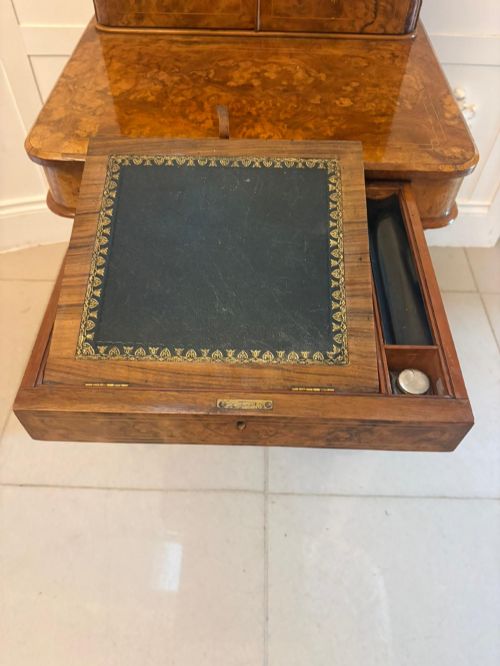 fig 4. A Victorian burr walnut Davenport desk with floral marquetry inlay, a brass top gallery, and carved scroll feet.