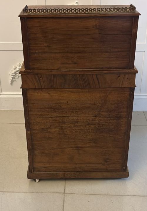 A Victorian burr walnut Davenport desk with floral marquetry inlay, a brass top gallery, and carved scroll feet. View IX